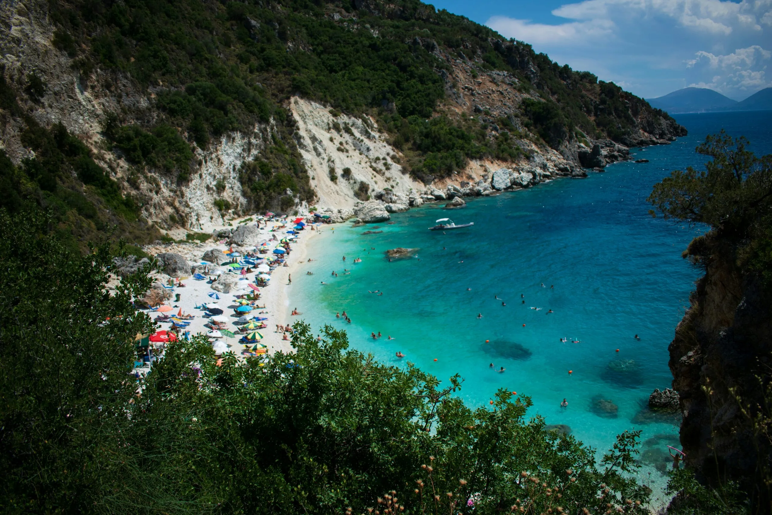 Turquoise water and rocky shoreline at Agiofili Beach in Lefkada