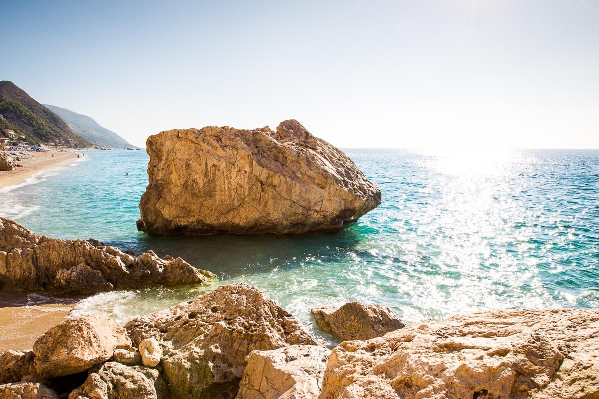 Kathisma Beach Guide 3 Kathisma Beach shoreline in Lefkada with clear blue sea and beach umbrellas