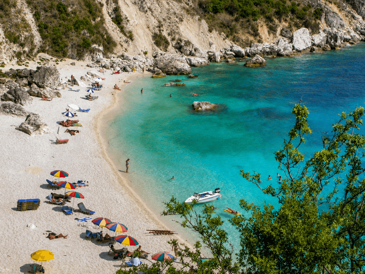 Agiofili Beach Guide 1 Agiofili Beach near Vasiliki, with a white pebble shore, umbrellas and turquoise water
