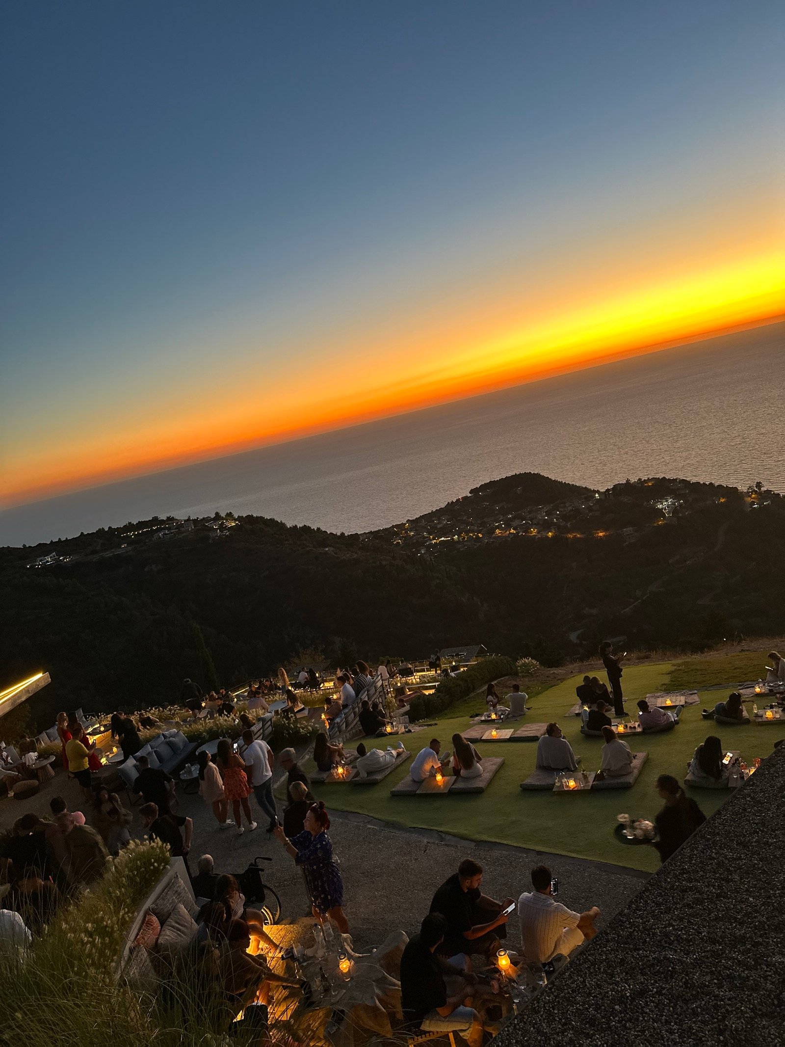 Romantic Things to Do Near Porto Katsiki 2 Outdoor seating overlooking the Ionian Sea at sunset in Exanthia, Lefkada.